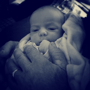 Newest grandchild in his Grandpa's hands